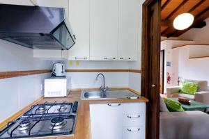 a kitchen with a stove and a sink in a room at Agriturismo Pimpinnacolo in Porto Ercole