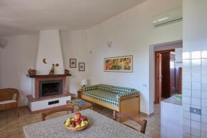 a living room with a table and a fireplace at Agriturismo Tesorino in Massa Marittima