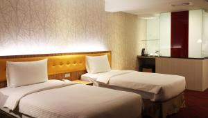 Postelja oz. postelje v sobi nastanitve Bamboo Hotel