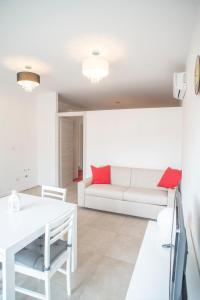 a living room with a white couch and a table at DiMora RIccaFrida - Luxury Home - in Prato