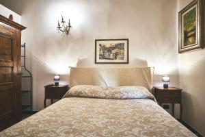 sypialnia z łóżkiem z 2 stolikami nocnymi i 2 lampami w obiekcie Affittacamere San Teodoro w Albendze