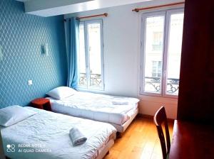 - 2 lits dans une chambre avec 2 fenêtres dans l'établissement Hôtel Central Bastille, à Paris