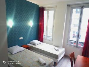 Posteľ alebo postele v izbe v ubytovaní Hôtel Central Bastille