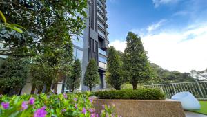 a building with trees and flowers in front of it at The Yanné, Onsen Hotel in Genting Highlands