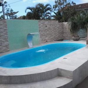 a large swimming pool with a water fountain at Pousada Familiar Morada Lua Nova in Florianópolis