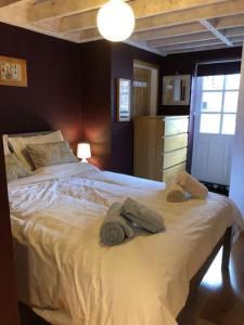 a bedroom with a large bed with towels on it at Bank Studio - luxury Cotswolds haven for two in Shipston on Stour
