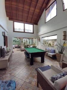 a large living room with a pool table in it at Pousada Familiar Morada Lua Nova in Florianópolis +64 photos