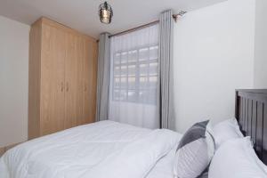 Postel nebo postele na pokoji v ubytování Athi Luxury Suites