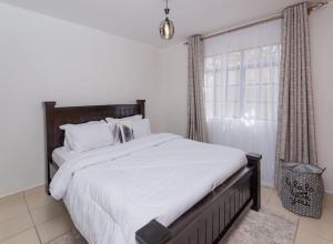 Postel nebo postele na pokoji v ubytování Athi Luxury Suites