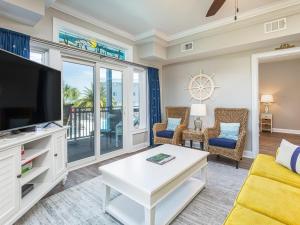 a living room with a tv and a couch at Bay View Villas 105 in Tybee Island