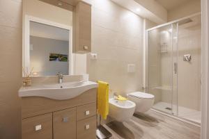 a bathroom with a sink and a toilet and a shower at Siena Living Apartment in Siena +51 photos
