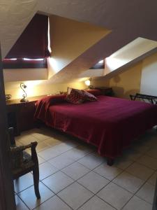 a bedroom with a large bed with a red blanket at Hotel Triskel in Jávea