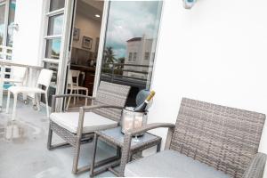 a balcony with chairs and a table and a window at Rooftop-Pool Suite with King Bed in Ocean Dr C303 in Miami Beach