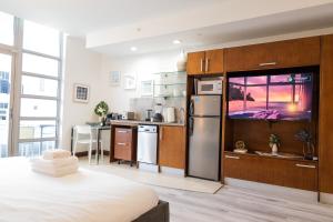 a bedroom with a kitchen with a tv in it at Rooftop-Pool Suite with King Bed in Ocean Dr C303 in Miami Beach
