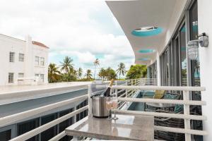 a balcony with a table and a view of the ocean at Rooftop-Pool Suite with King Bed in Ocean Dr C303 in Miami Beach