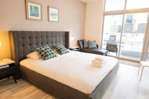 a bedroom with a large bed with a large window at Rooftop-Pool Suite with King Bed in Ocean Dr C303 in Miami Beach +7 photos