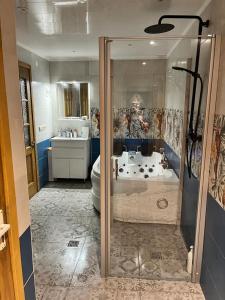 a bathroom with a shower and a tub and a toilet at Albatross in Kaunata