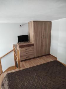um quarto com uma cama e um armário de madeira em Lakmos Studios em Ioannina