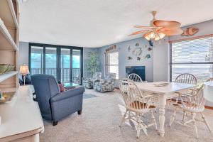 a kitchen and living room with a table and chairs at Sand Dollar II 408 in Saint Augustine