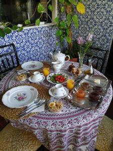 a table with a tea set with food on it at Swara Slow Living Home in Aveiro