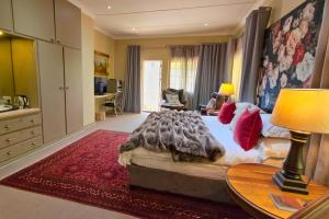 a bedroom with a bed and a table with a lamp at Ben's Bed and Breakfast in Pretoria