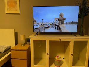 a flat screen tv on top of a cabinet at Dream Home in The Walking Street in Budapest
