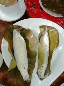 a white plate with three food items on it at Kuma Beach side Villa in Wadduwa