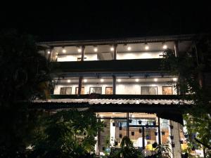 a building with lights on top of it at night at Aariv Inn in Baga