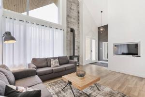 a living room with a couch and a tv at Initial - Soeur No19 - MSA in Saint-Férréol-les-Neiges