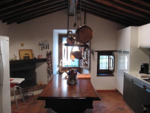 a kitchen with a wooden table in the middle of it at Casale La Petrosa in Radda in Chianti