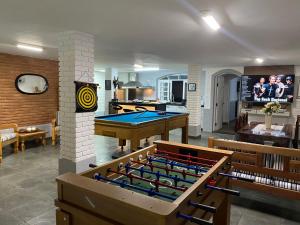 a living room with a pool table and ping pong ball at Morada do Sol. in São Sebastião