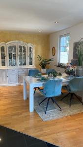 a living room with a white table and blue chairs at Marienburg in Lorsch