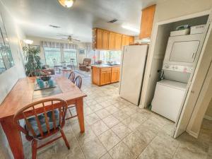 a kitchen with a table and a white refrigerator at Comal River Condo 375 in New Braunfels