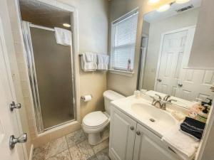a bathroom with a toilet and a sink and a shower at Comal River Condo 375 in New Braunfels +17 photos