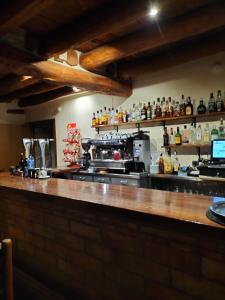 a kitchen with a bar with a counter top at Hotel Molino Alto in Aliaga