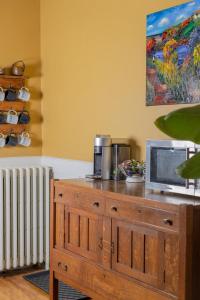 a wooden dresser with a microwave on top of it at The Olde Anchor Bed & Breakfast in Murray River