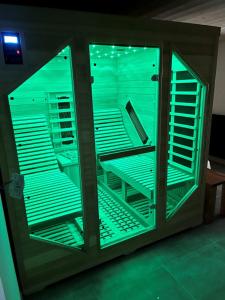 a glass cabinet with blue lights in a room at House type chalet - sauna and balneo - 14 pers in Gérardmer