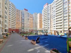 a playground in a city with tall buildings at Testemiteanu apartment, free wifi available in Chişinău