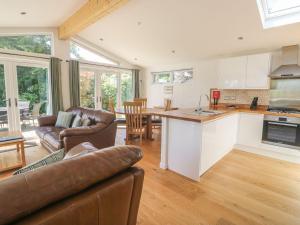 a kitchen and living room with a couch and a table at 15 Horizon View in Liskeard