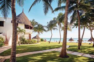 a villa with palm trees and the beach at Maroma, A Belmond Hotel, Riviera Maya in Puerto Morelos