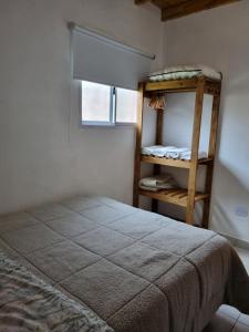 a bedroom with a bunk bed and a window at Río Tigris Apart 1 in Tigre