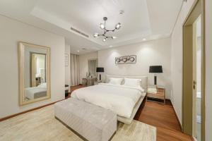 ドバイにあるParamount Midtown Luxury 2 Bedroom With Full Burj-Khalifa Viewのベッドルーム(大きな白いベッド1台、大きな鏡付)