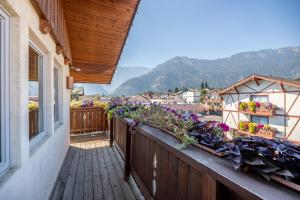 a balcony of a house with flowers on it at Solstice Suites in Leavenworth