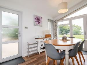 a dining room with a table and chairs at 9 Horizon View in Liskeard