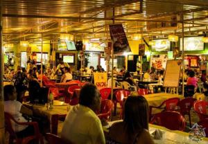 a group of people sitting at tables in a restaurant at Sol de Bora Bora 101 in Salvador +58 photos