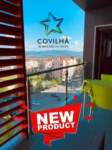 a new product sign on the balcony of a building at Apartamento ALTAMIRA T2 SERRA SHOPPING in Covilhã