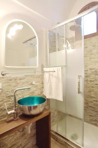 a bathroom with a bowl sink and a shower at L'Arco in Terrasini