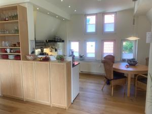 a kitchen with a table and a dining room at Stadtpark-Oase in Erfurt