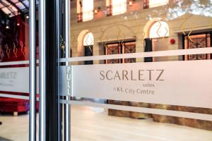 a sign in a window of a store at Scarletz Suites KLCC by Mana-Mana in Kuala Lumpur