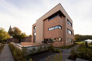 a brick building with a church in the background at Luxus Penthouse mit Kamin und Sonnenterasse in Bedburg Hau